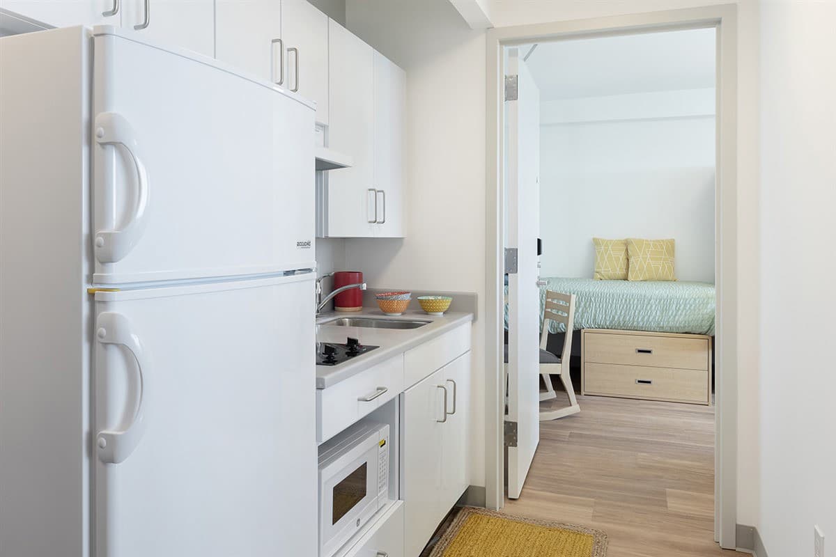 Kitchens in suites include a sink, ample cabinets, a large refrigerator, a two-burner cooktop, and a microwave oven.